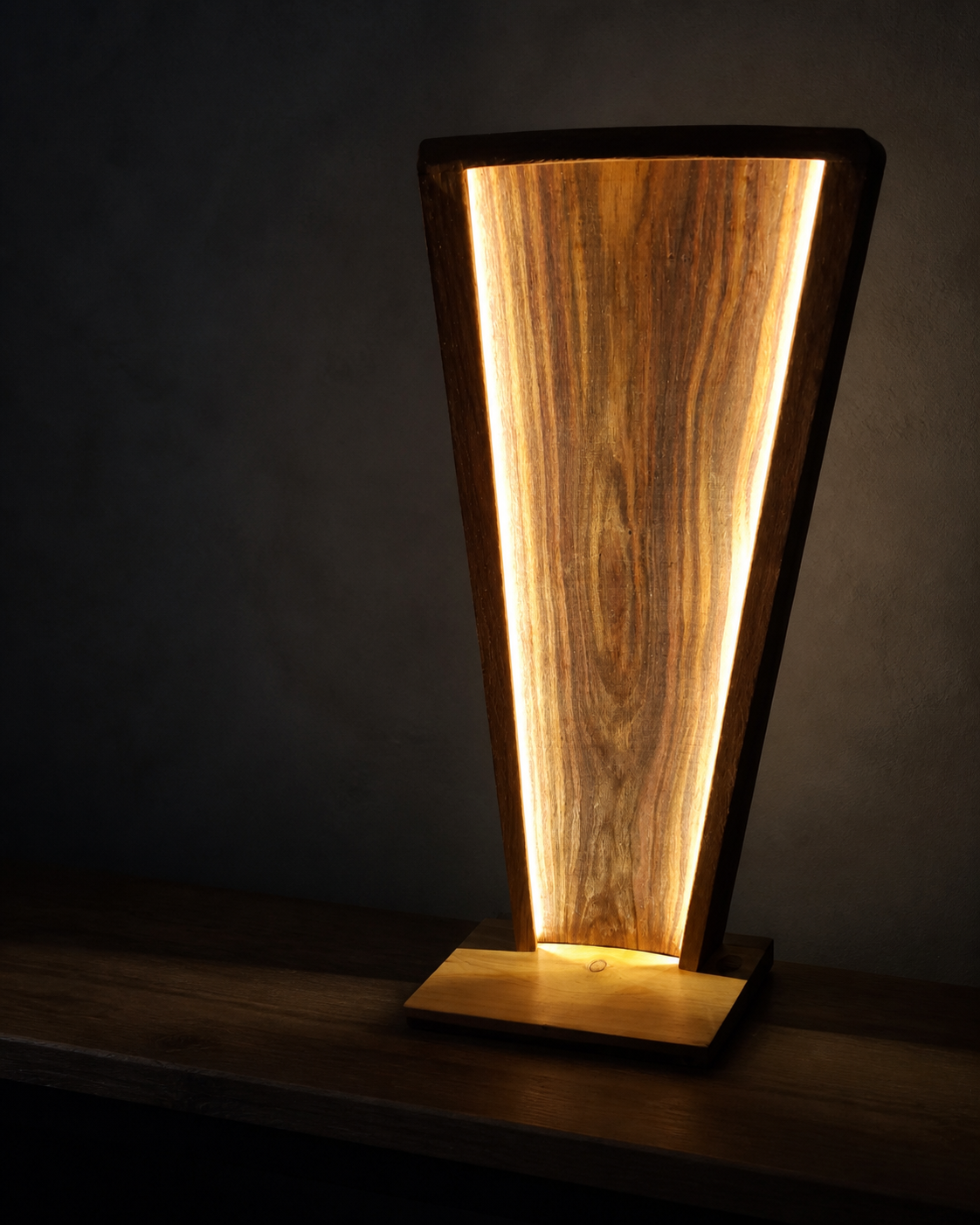 Prepared image of an illuminated sculptural timber table lamp